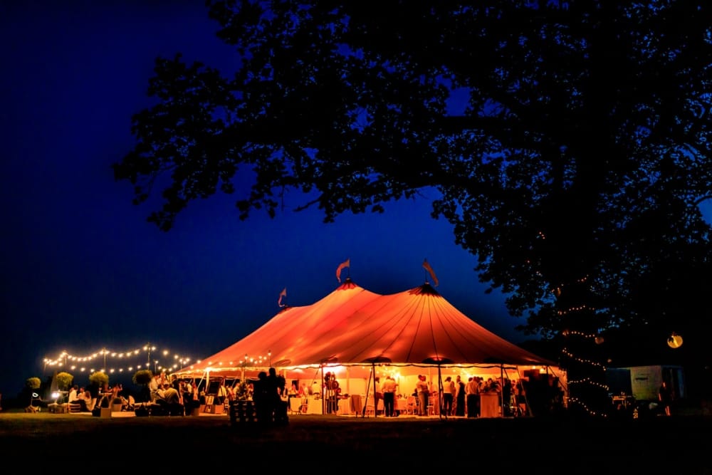 wedding guests outside drinking at sunset