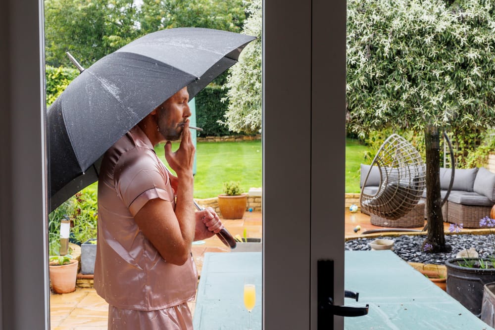 bride outside with her umbrella in the morning