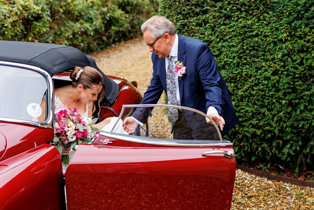bride and dad getting into car