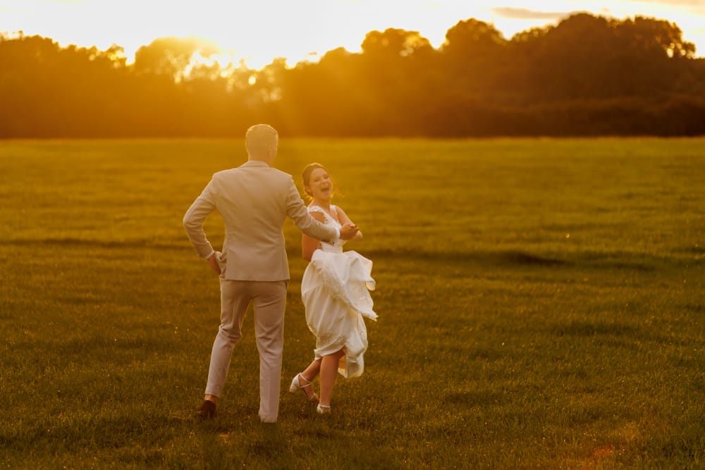 bride and groom in he sunset