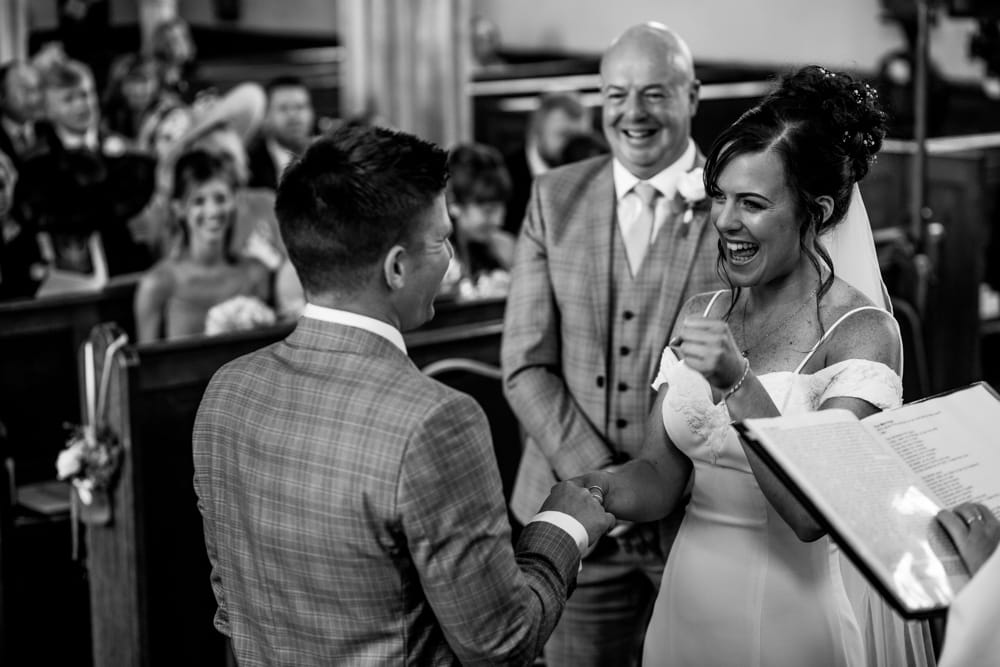 bride and groom laughing during ceremony
