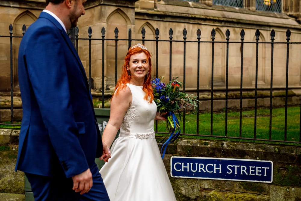 bride and groom walking from church