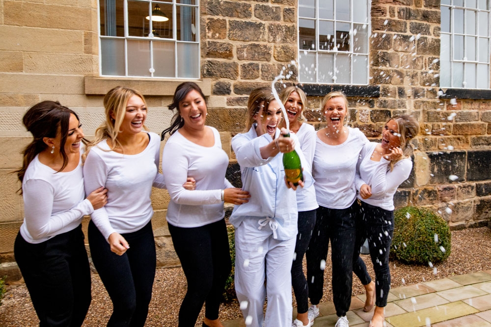 bridesmaids having fun with champagne
