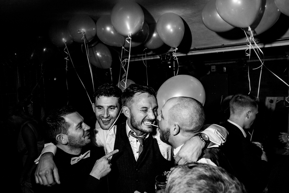 groom and his friends on the dance floor