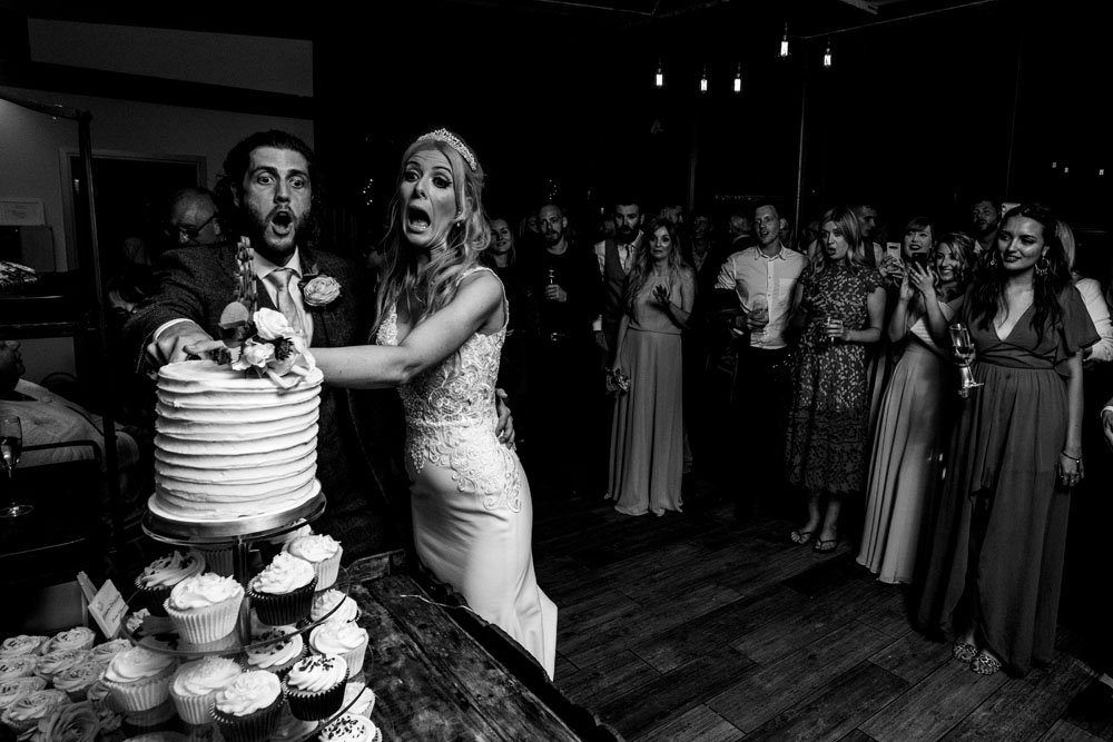 bride and grom cutting the cake