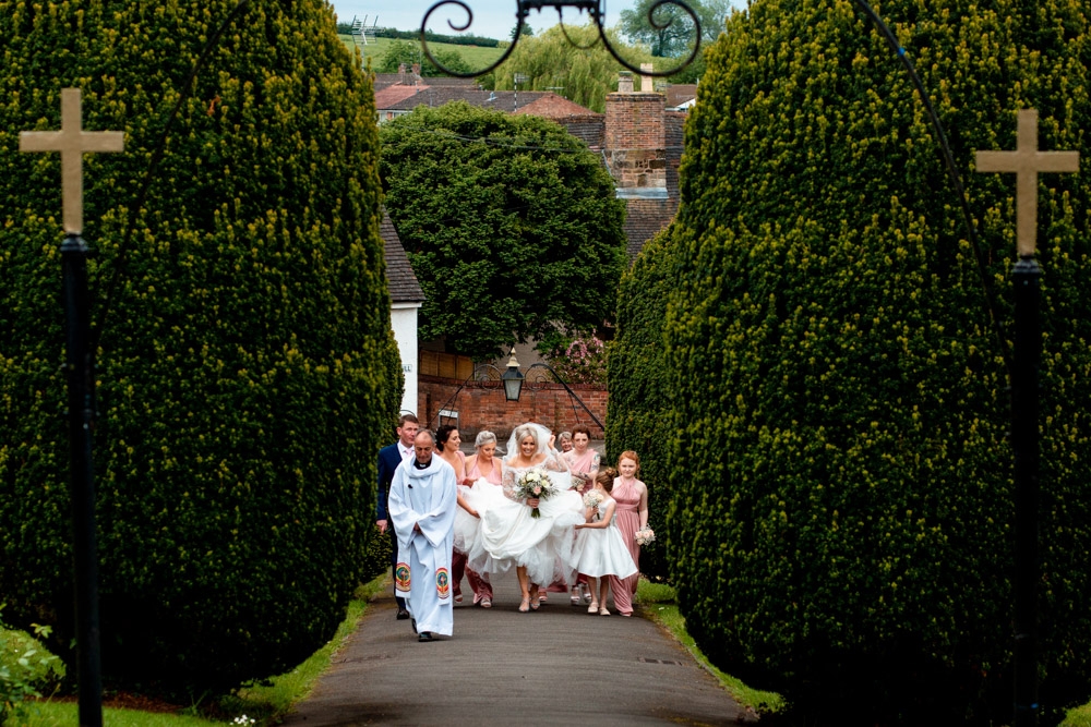 bride entering the grounds of the church