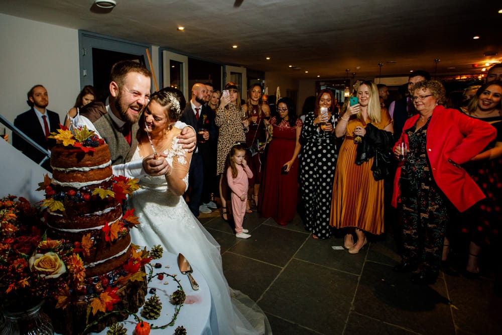 bride and groom cutting the cake