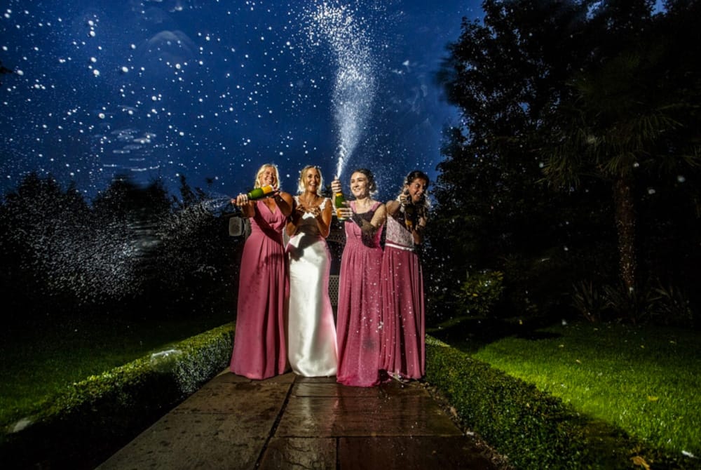 bridal party spraying champagne